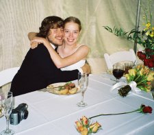 The groom & bride at the head table embrace.