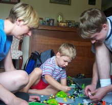 DeeAnn, Will, and Phil playing with a pile of Legos