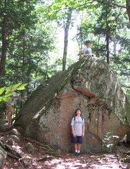 Phil atop a boulder, more than twice the height of Kevin