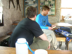 Steve and Scott seated at tables indoors