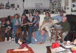 Grandpa in the easy chair with a slide projector, with nine onlookers