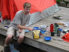 Phil with cooking gear, including pot on lightweight gas stove