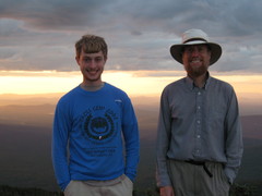 2 guys in front of a sunset