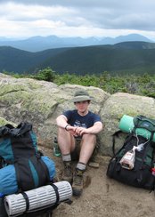 Kevin sitting by a rock