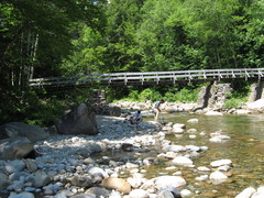 stream, bridge, with two guys on the bank