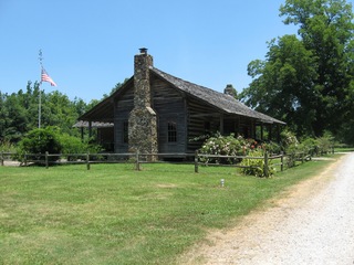 shack with riding mower in front