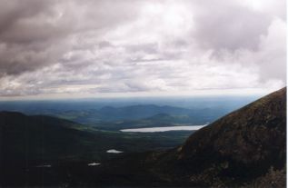 a layer broken clouds makes dramatic lighting of the mountainsides and lowlands